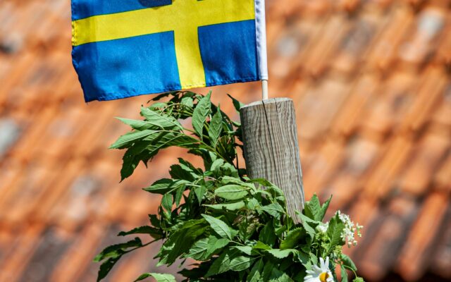 Schwedische Flagge auf der Spitze einer Midsommarstange auf Öland